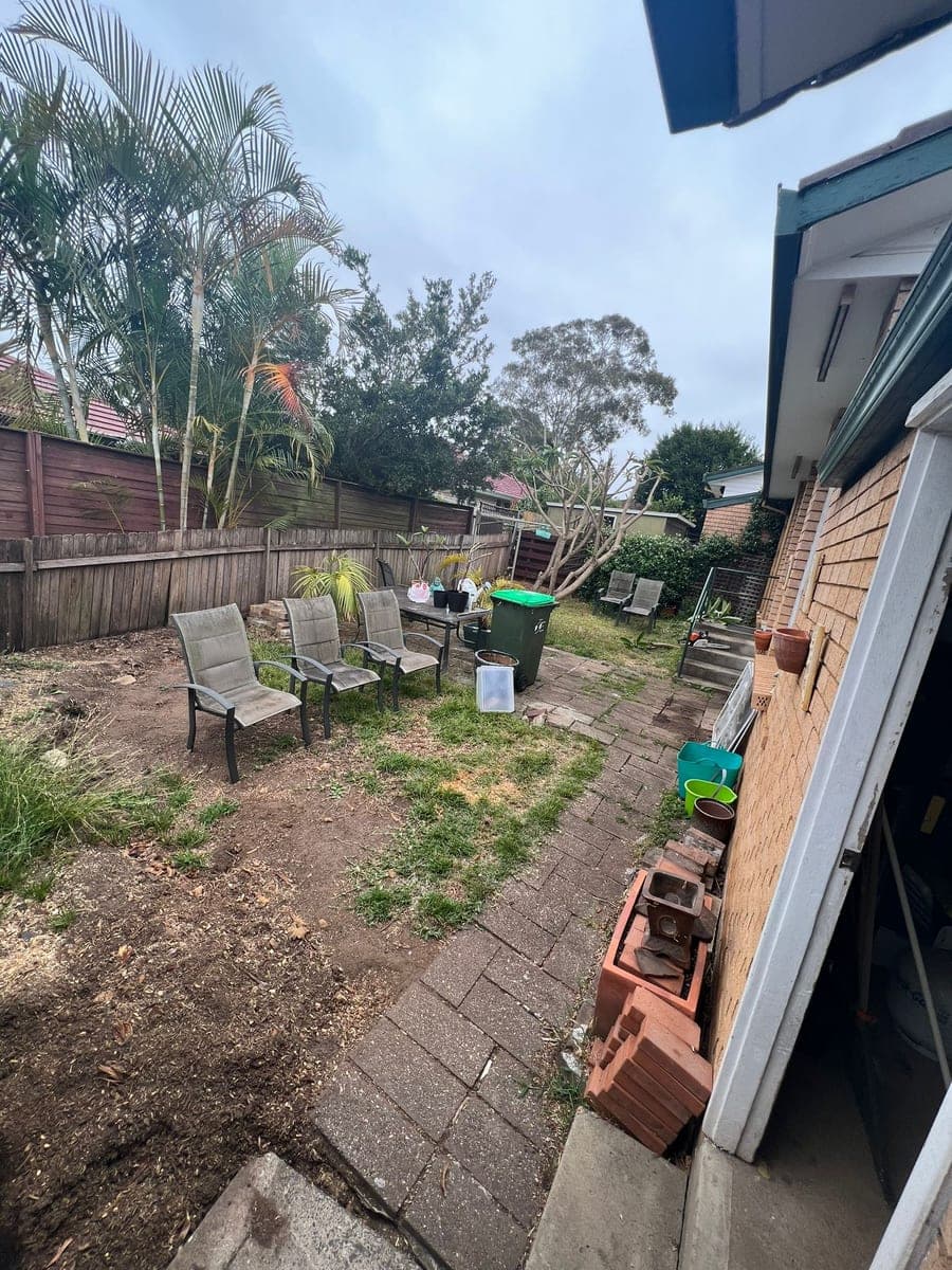 Before - Main backyard transformation from cluttered yard to elegant turf and pergola