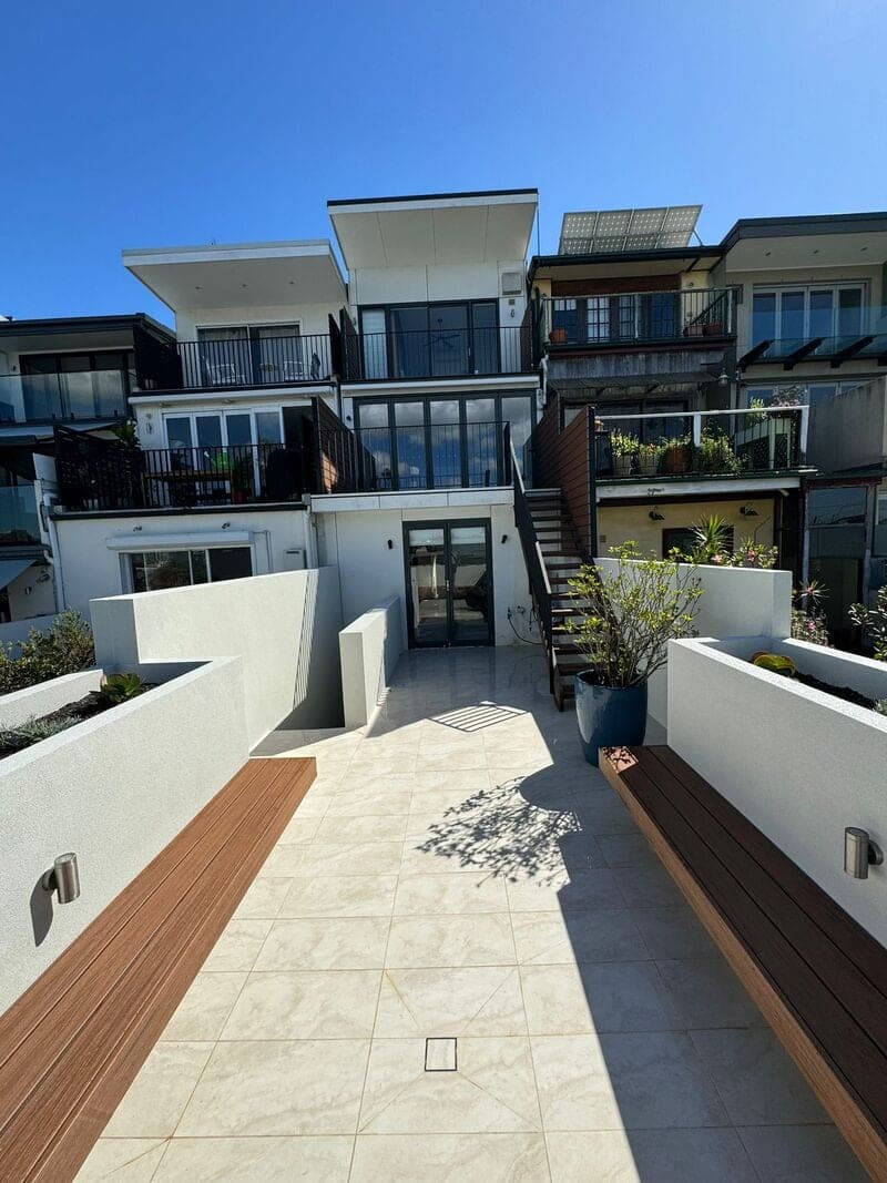 After - View towards house with rendered walls and tiling