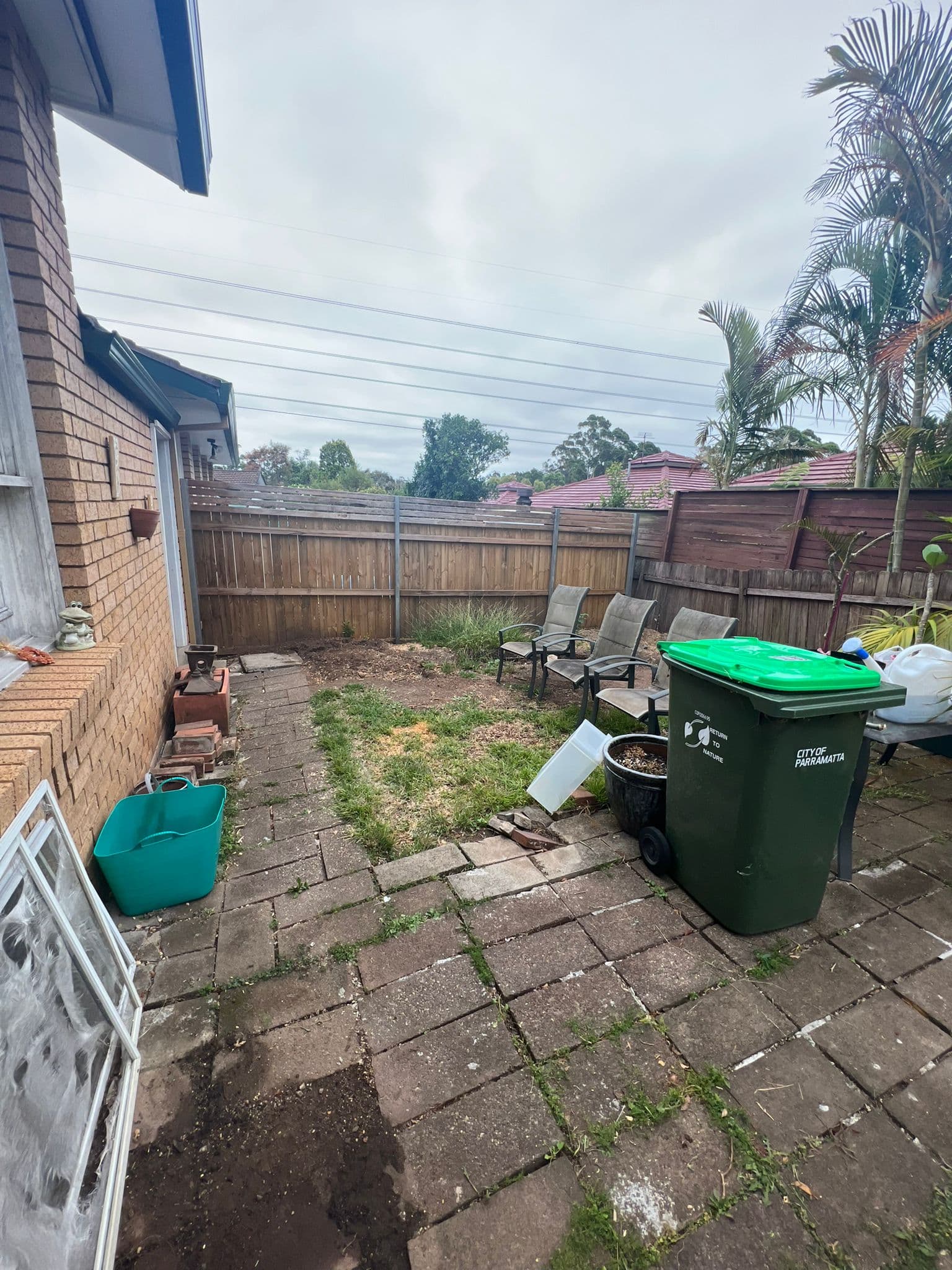 After: Transformed backyard with pergola, artificial turf and modern landscaping features