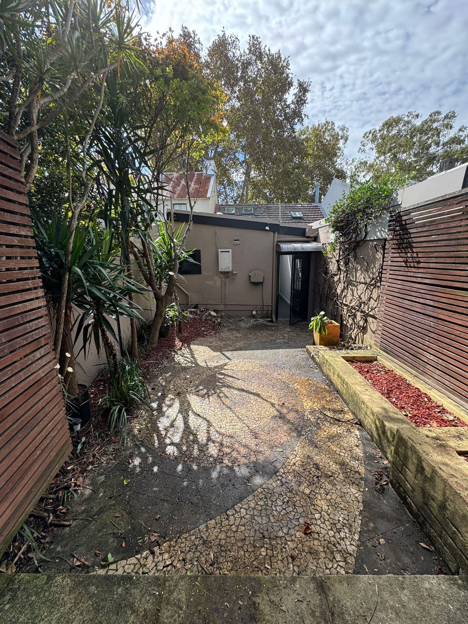 Before - Transformation from old concrete pathway to cushioned synthetic turf with rubber shock mat underlay