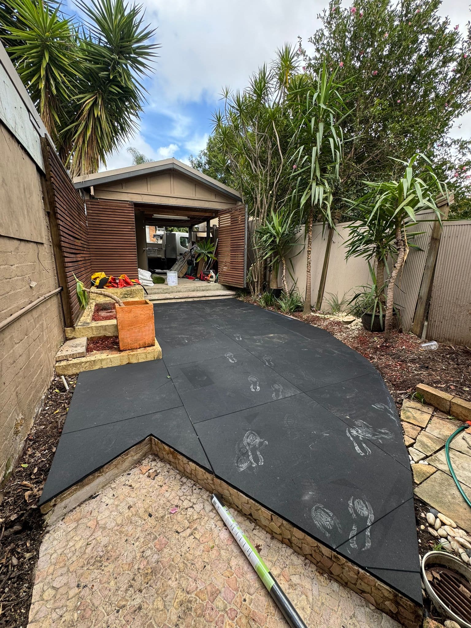 Full view of the transformed concrete pathway now covered with lush, cushioned synthetic lawn