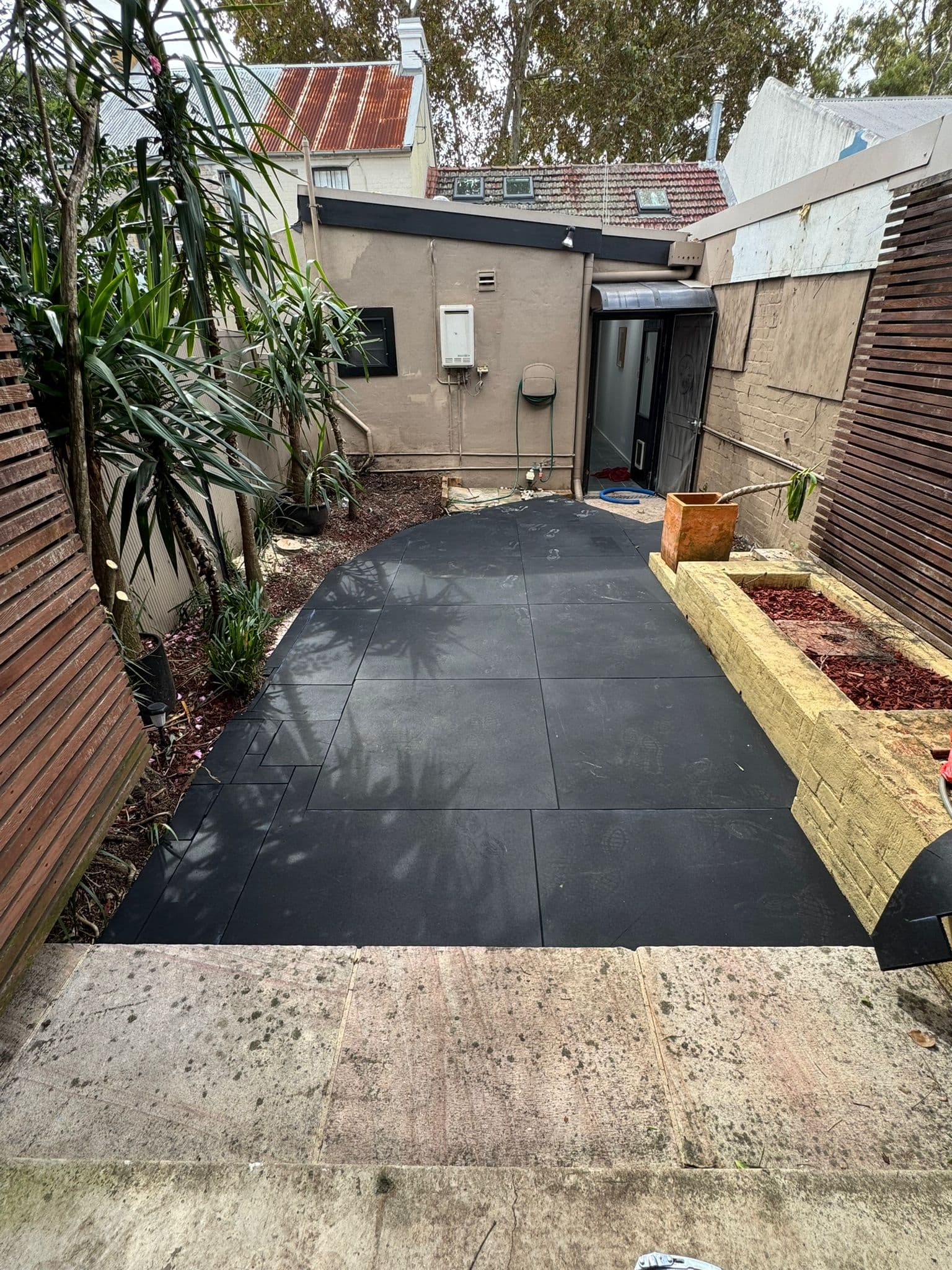 After - Transformation from old concrete pathway to cushioned synthetic turf with rubber shock mat underlay