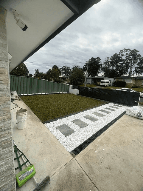 Garden edging creating clean borders between lawn and pebbled areas