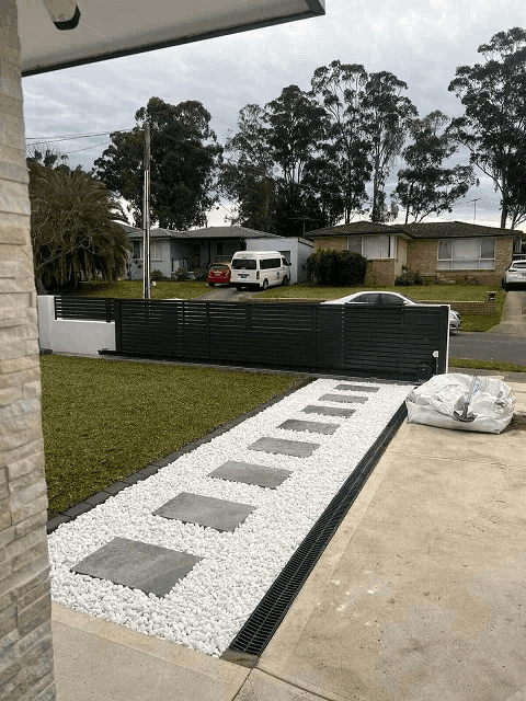 Full view of the completed front yard transformation showing all elements together