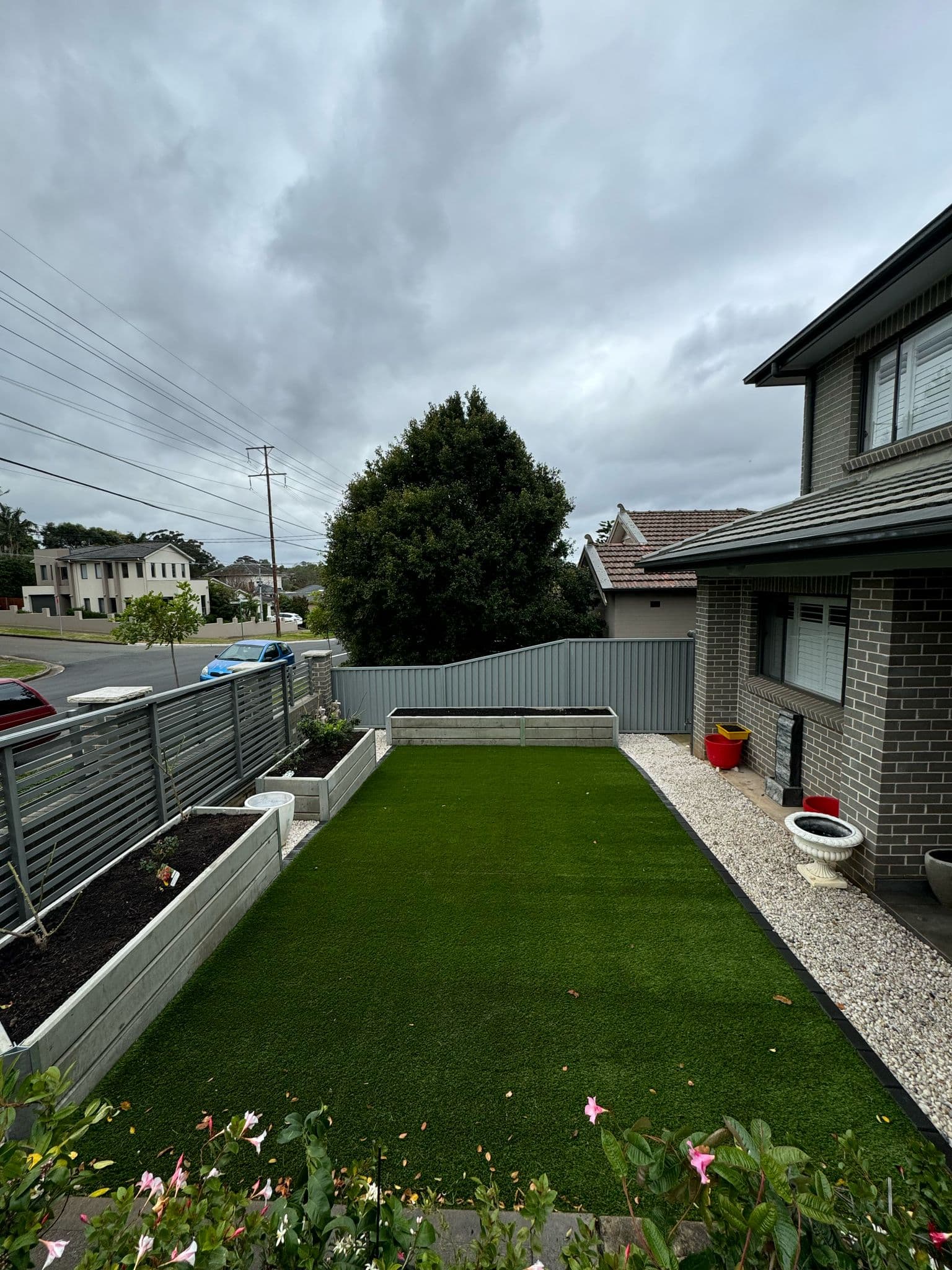 After - Transformation of the front yard area with synthetic turf, planter boxes and garden edging