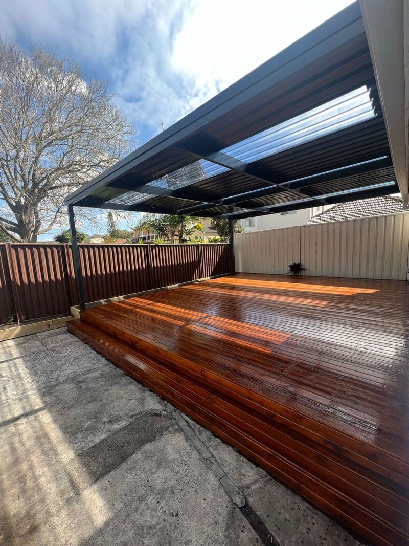 Evening view of the completed outdoor living space with ambient lighting