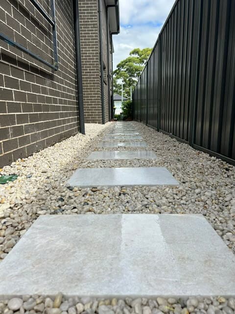 Overview of the completed stepping stone pathway with white Cowra pebbles on one side of the property