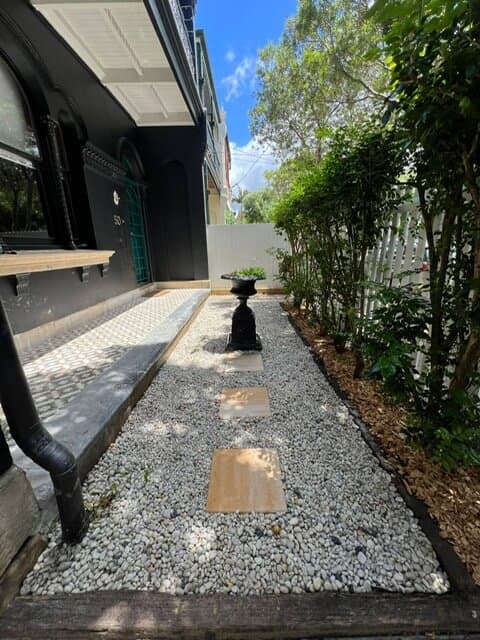 Stepping stone pathway with white Cowra pebbles creating a modern, structured look