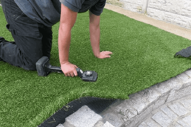 Realistic synthetic grass lawn with pet-friendly drainage and clean edging
