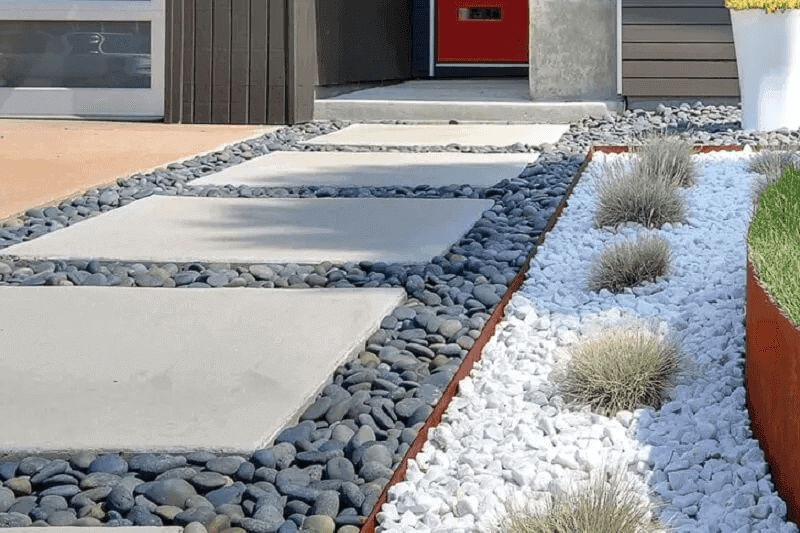 Japanese-style stepping stone path set in pebbles with surrounding greenery