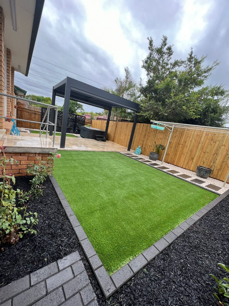 Dark garden edging defining an artificial lawn in Balmain