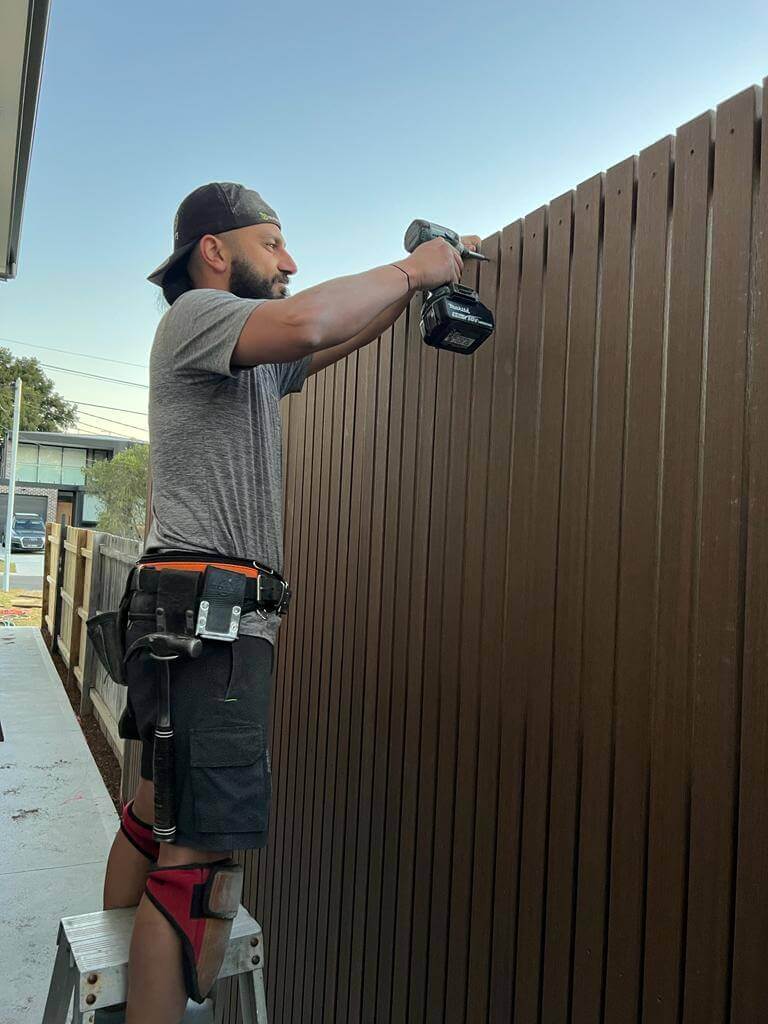 Outdoor Blitz team member working on a fence